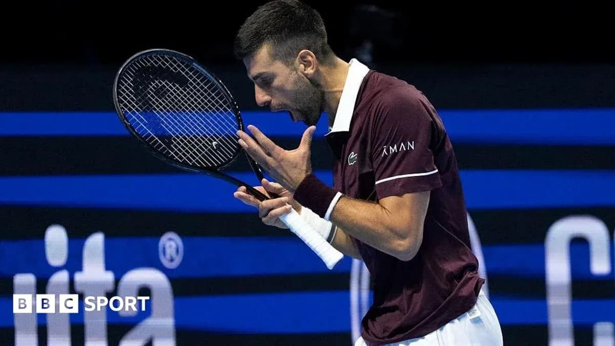 Tennis player celebrating a point with racket raised Tennis player celebrating a point with racket raised