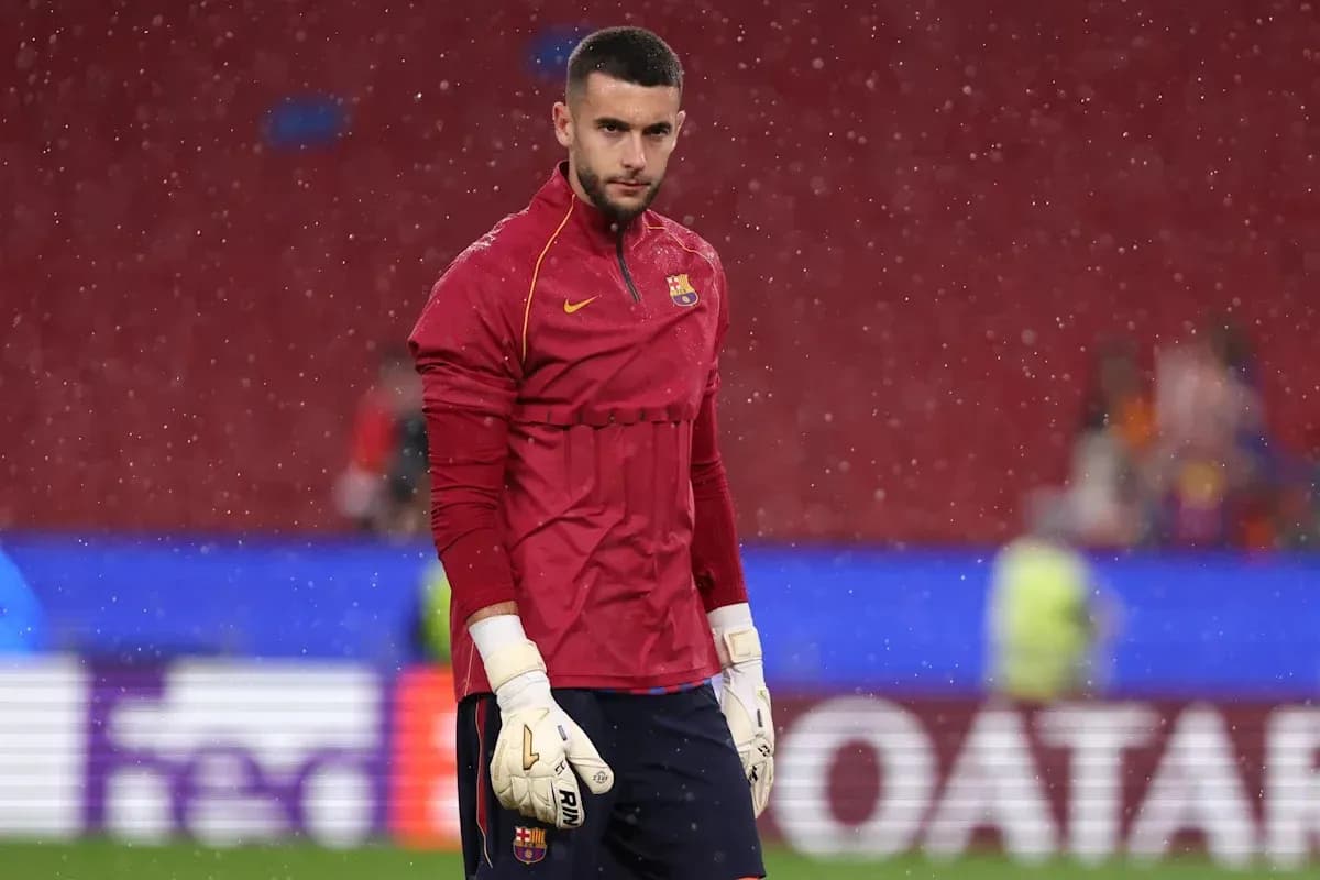 Goalkeeper in red jersey warming up in rain Goalkeeper in red jersey warming up in rain
