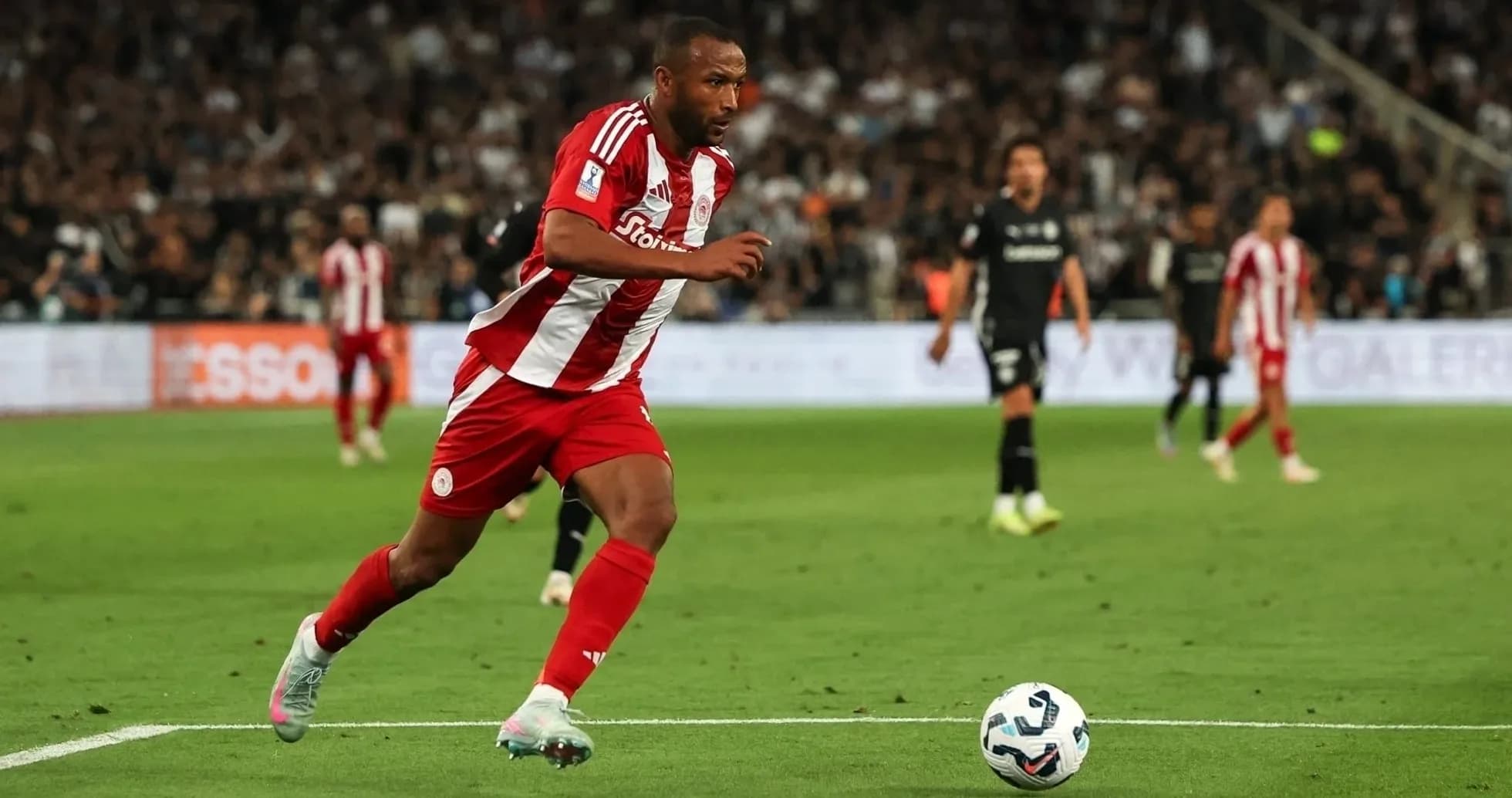 Olympiakos player dribbling during UEFA match Olympiakos player dribbling during UEFA match