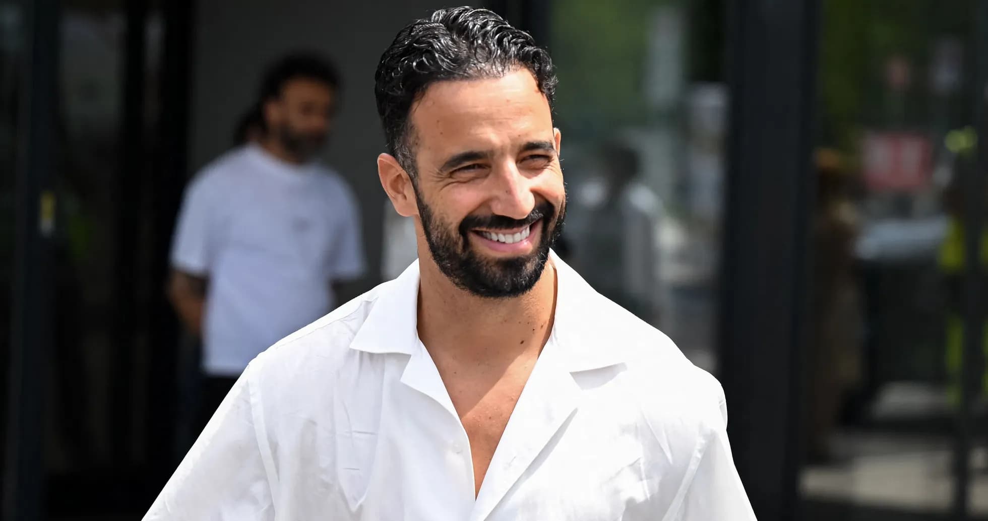 Man in white shirt smiling outdoors Man in white shirt smiling outdoors