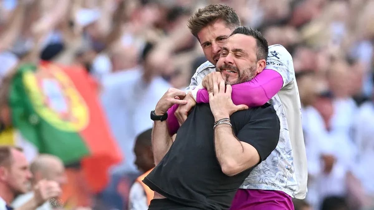 Two coaches celebrating with a hug during match Two coaches celebrating with a hug during match