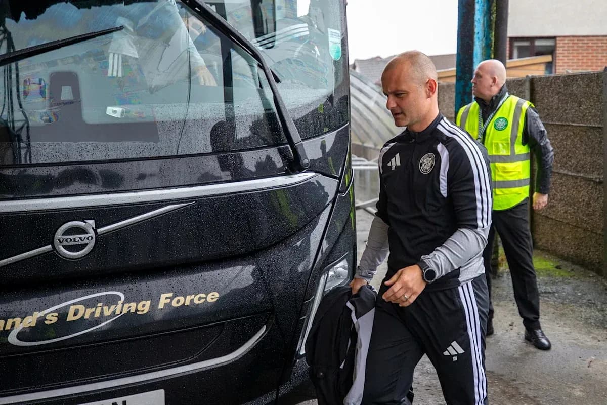 Coach and staff arriving at team bus in rain Coach and staff arriving at team bus in rain