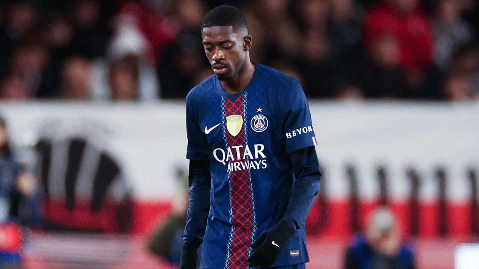 Player in PSG jersey walking on the field Player in PSG jersey walking on the field
