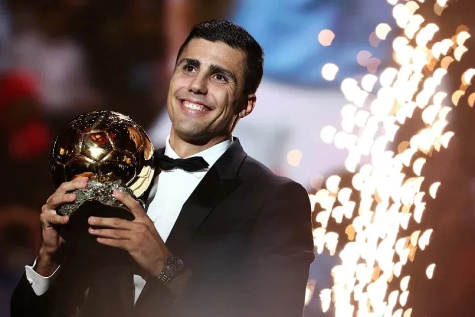 Player holding Ballon d'Or trophy at ceremony Player holding Ballon d'Or trophy at ceremony