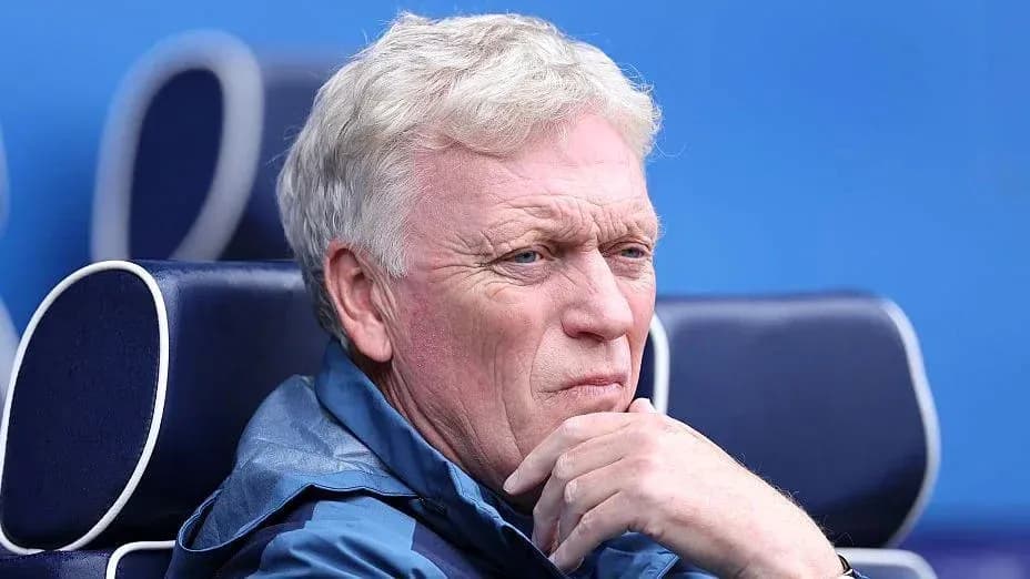Coach seated on bench during match Coach seated on bench during match