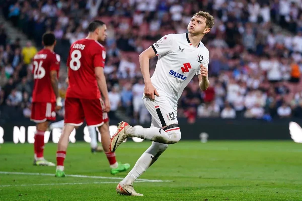Player celebrating a goal during a football match Player celebrating a goal during a football match