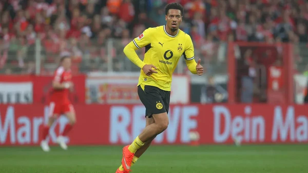 Player in yellow kit celebrating during a match Player in yellow kit celebrating during a match