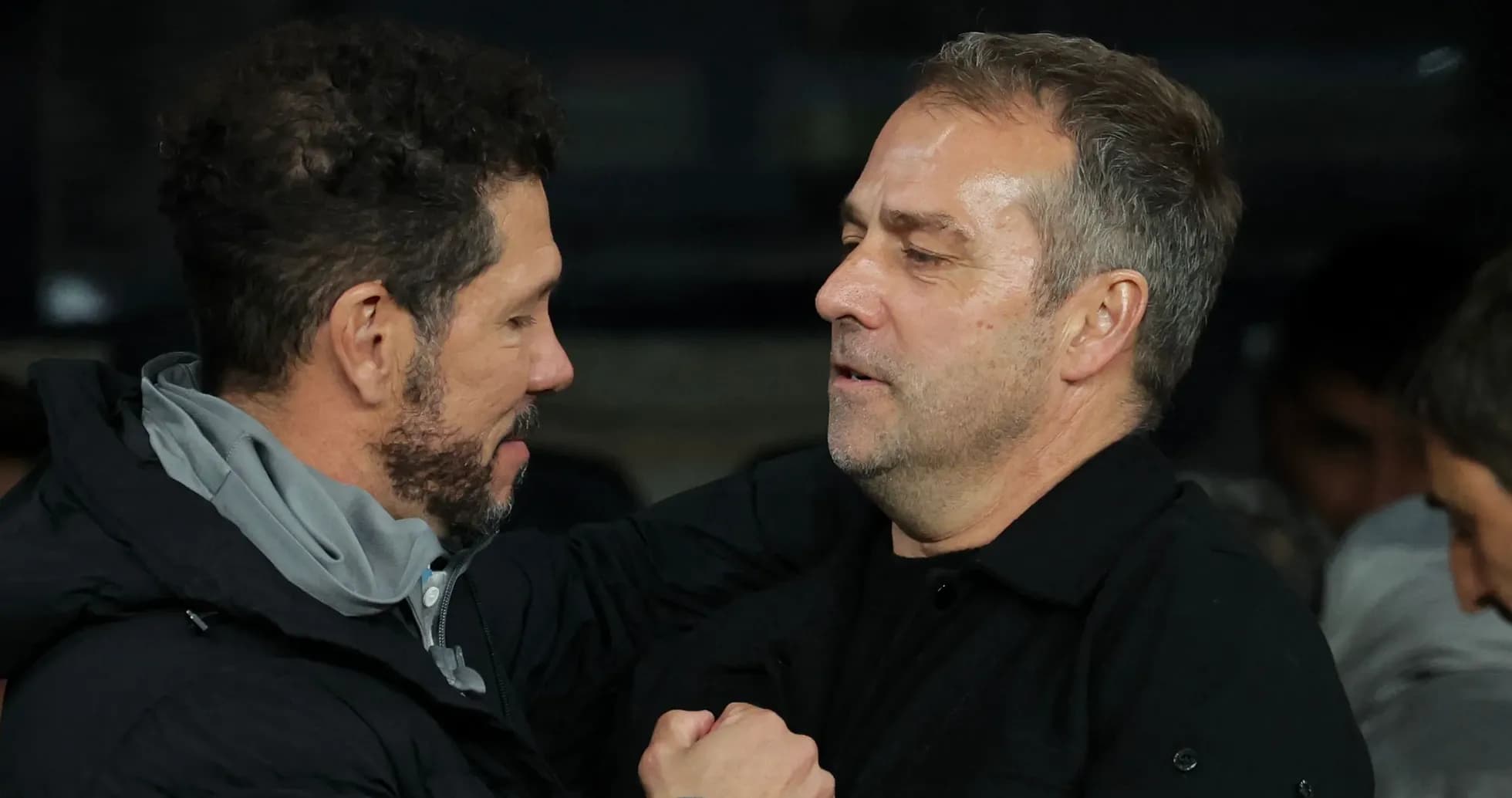 Two coaches embracing during a match event Two coaches embracing during a match event