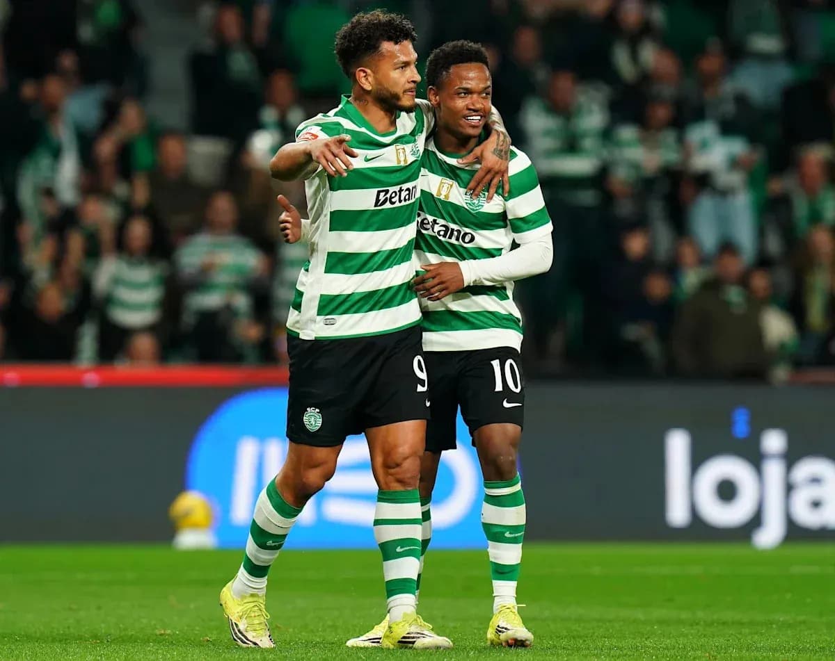 Two players celebrating a goal on the field Two players celebrating a goal on the field