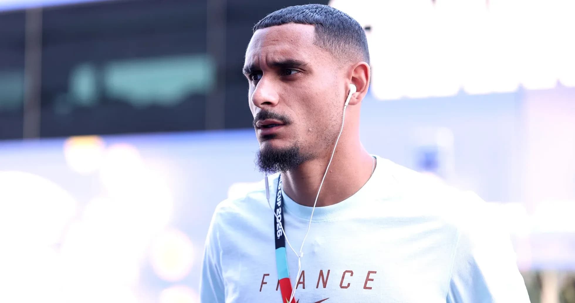 Player wearing earbuds, arriving at event venue Player wearing earbuds, arriving at event venue