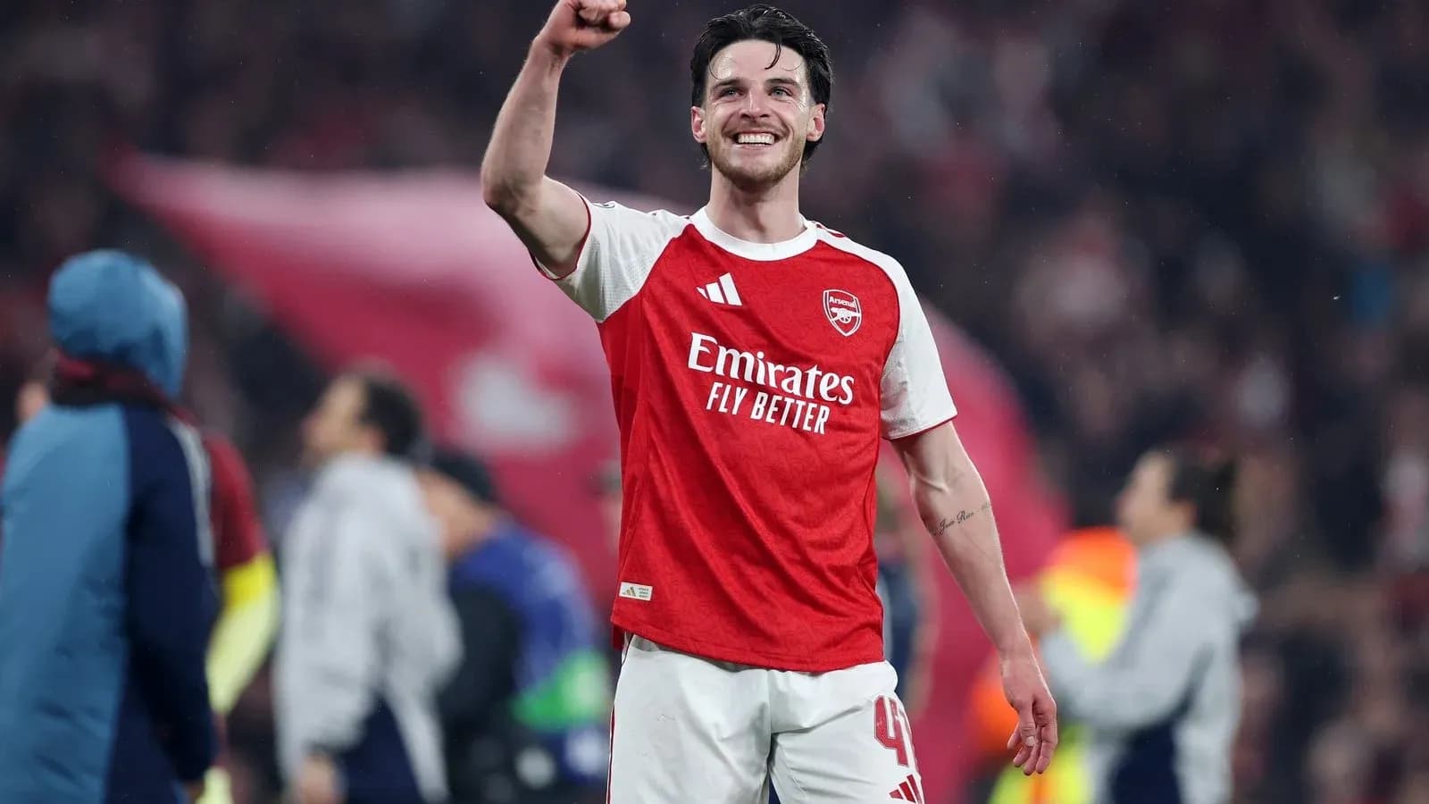 Player celebrating victory in Arsenal jersey Player celebrating victory in Arsenal jersey