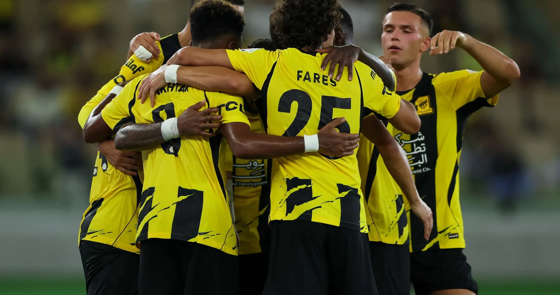 Team celebrating a goal with yellow jerseys Team celebrating a goal with yellow jerseys