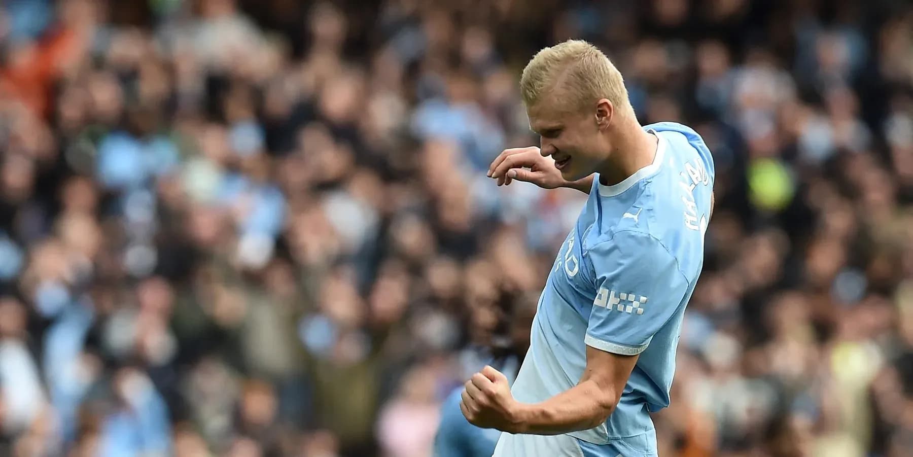 Player celebrating goal in front of cheering crowd Player celebrating goal in front of cheering crowd