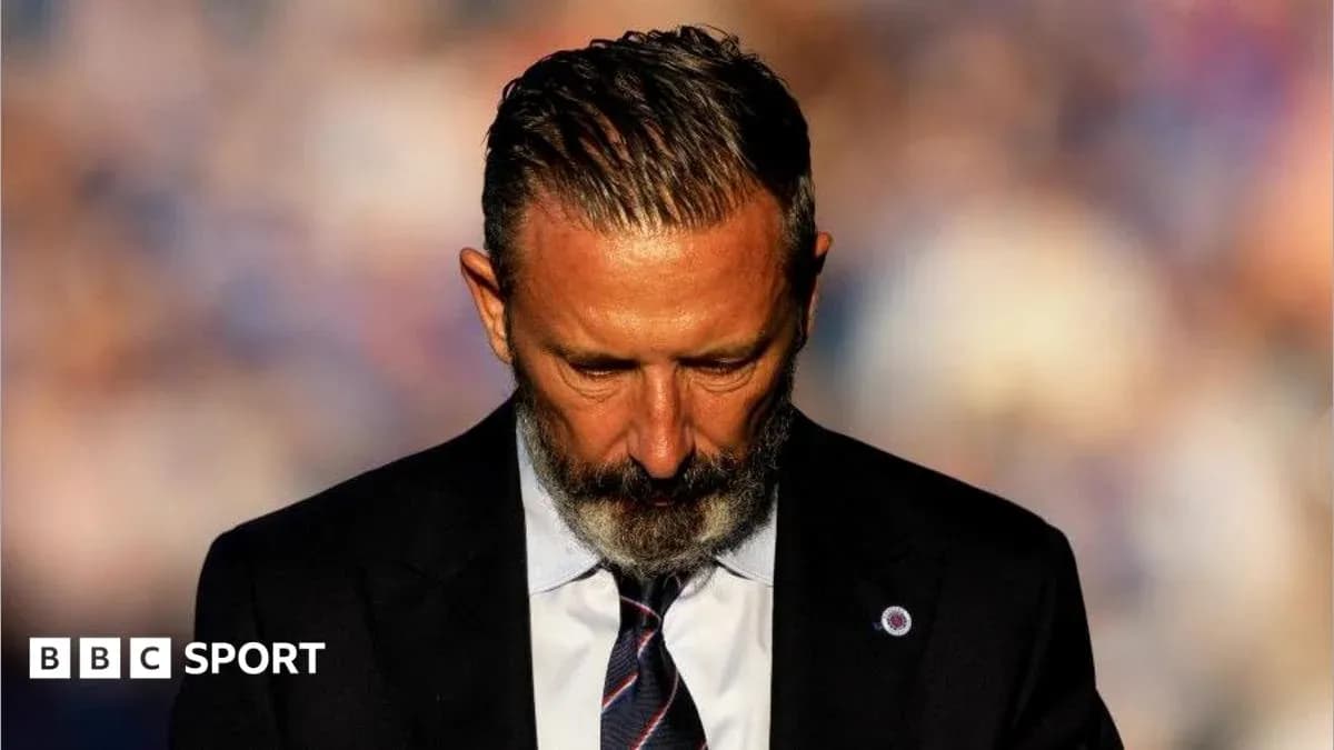 Man in suit with head down, focused expression Man in suit with head down, focused expression