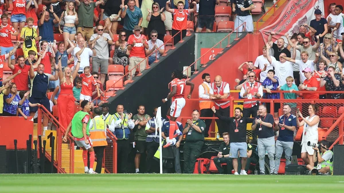 Player celebrating with fans at stadium after goal Player celebrating with fans at stadium after goal