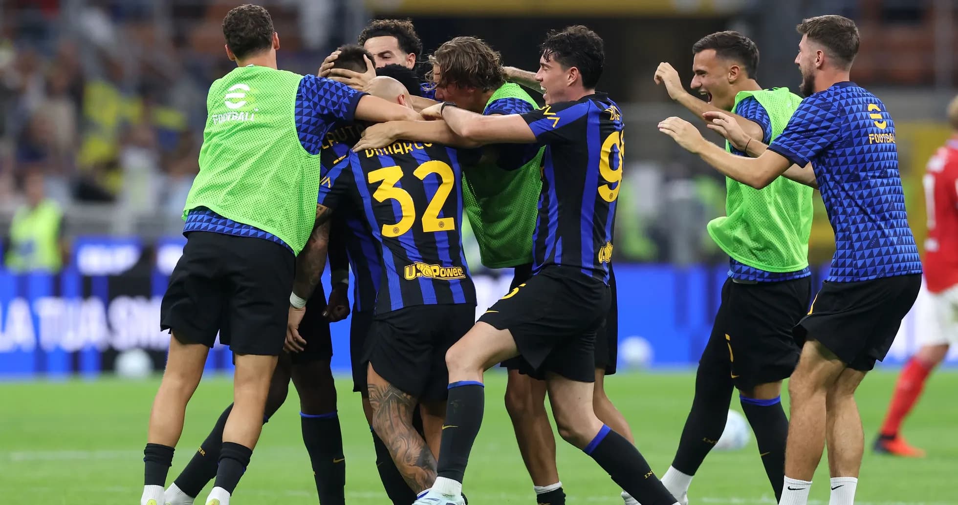 Players celebrating a goal on the pitch Players celebrating a goal on the pitch