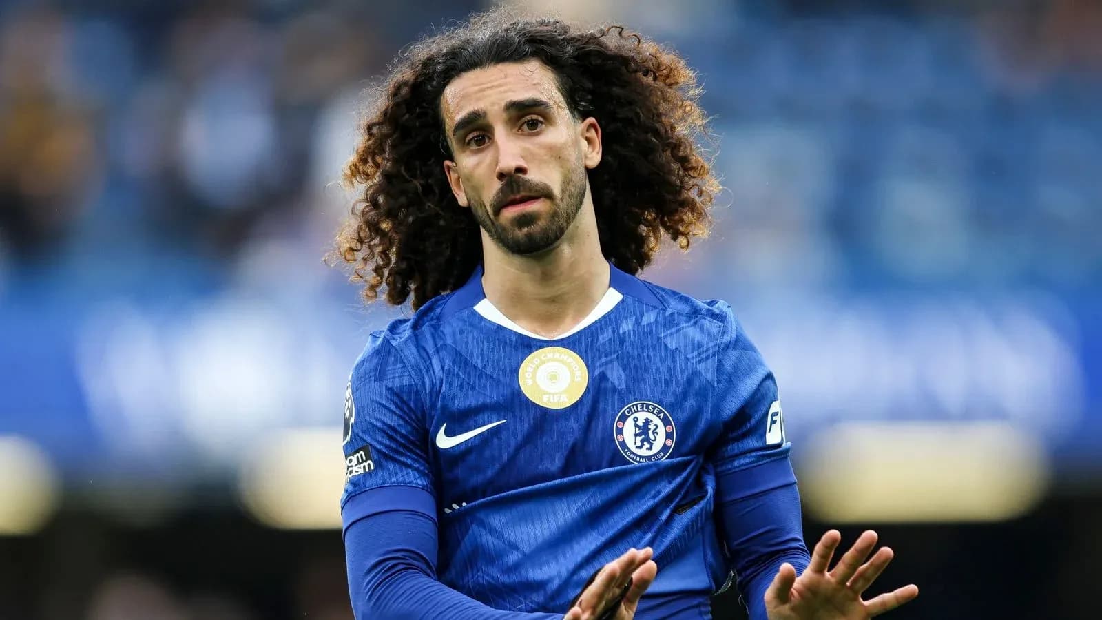 Player in blue Chelsea jersey gesturing on field Player in blue Chelsea jersey gesturing on field