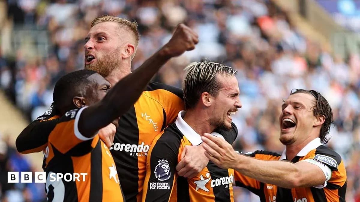 Four players celebrating a goal on the field Four players celebrating a goal on the field
