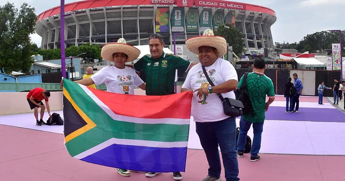 Fans holding South African flag outside stadium Fans holding South African flag outside stadium