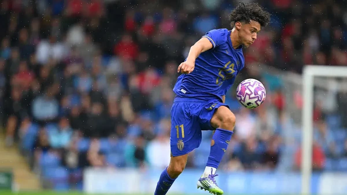 Player in blue jersey controlling the ball during match Player in blue jersey controlling the ball during match