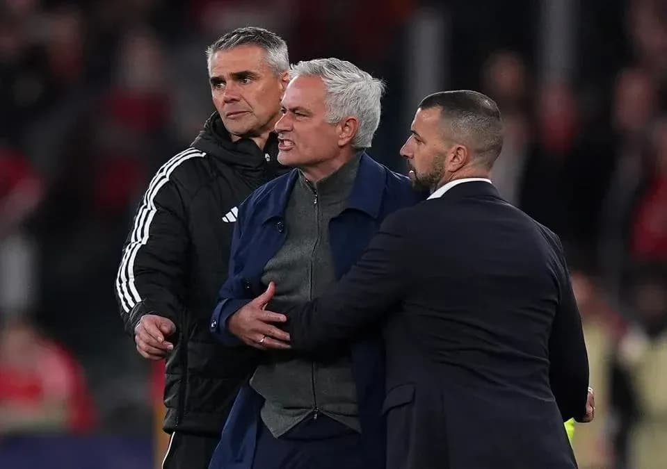 Manager being restrained by staff during match Manager being restrained by staff during match