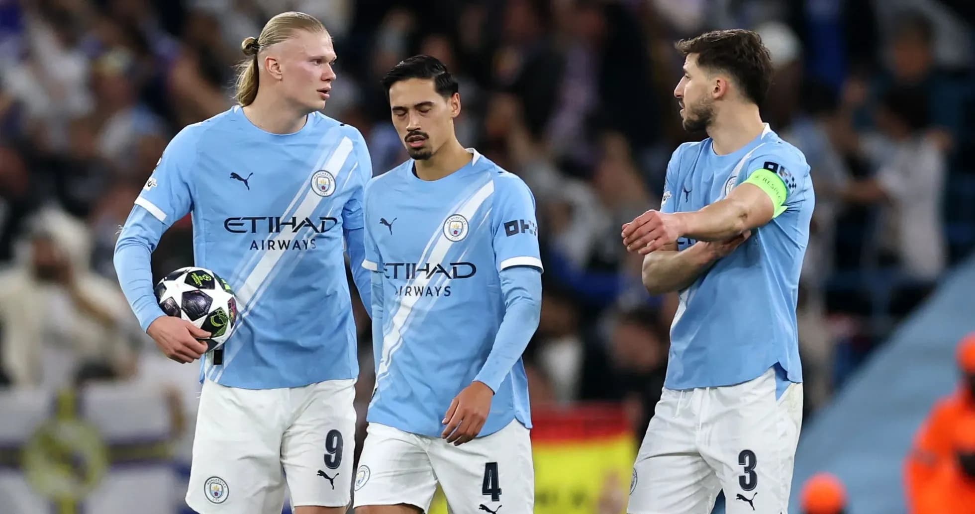 Three Manchester City players discussing during a match Three Manchester City players discussing during a match