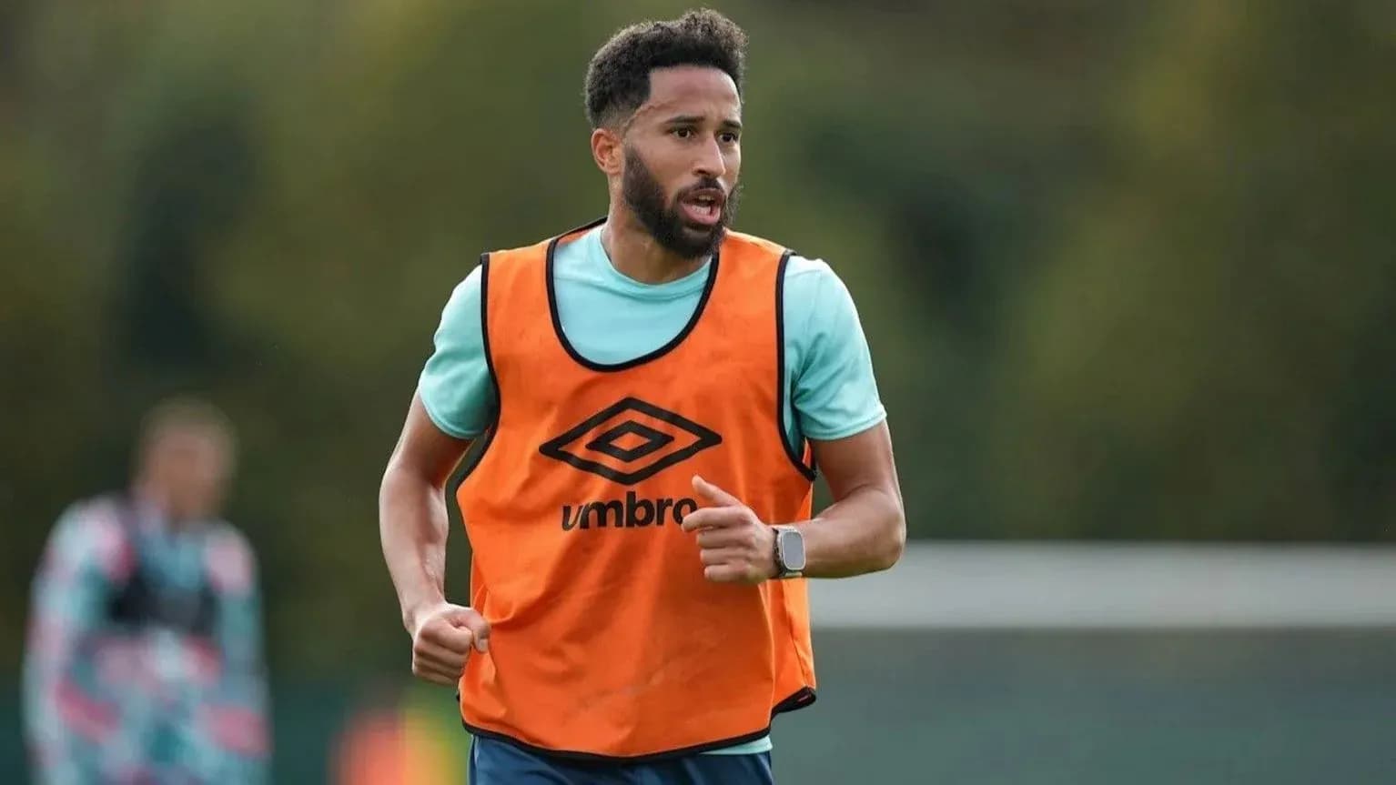 Player wearing training bib running during practice Player wearing training bib running during practice