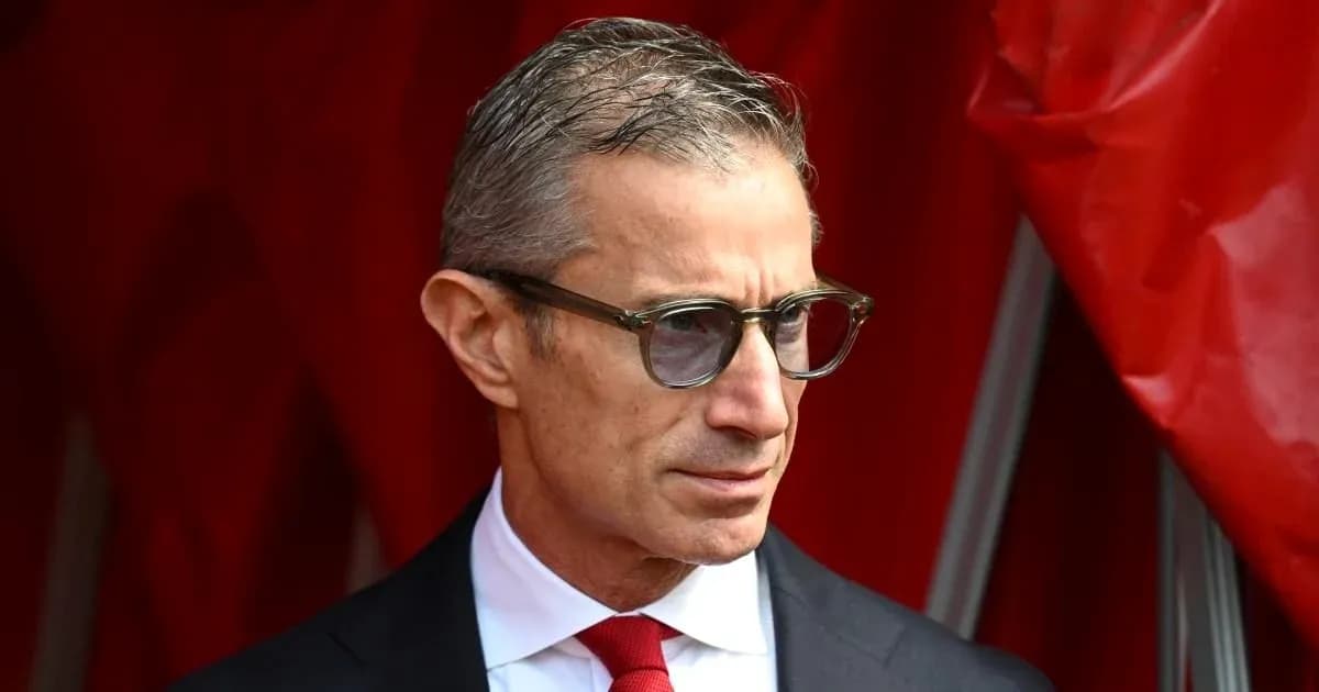 Man in glasses standing near red backdrop Man in glasses standing near red backdrop