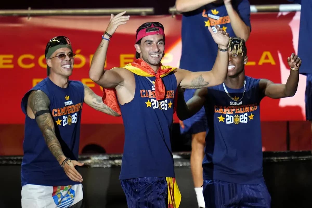 Players celebrating on stage with championship shirts Players celebrating on stage with championship shirts