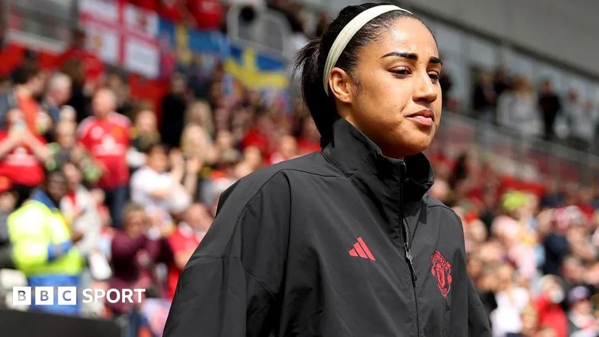 Player walking onto pitch with crowd in background Player walking onto pitch with crowd in background