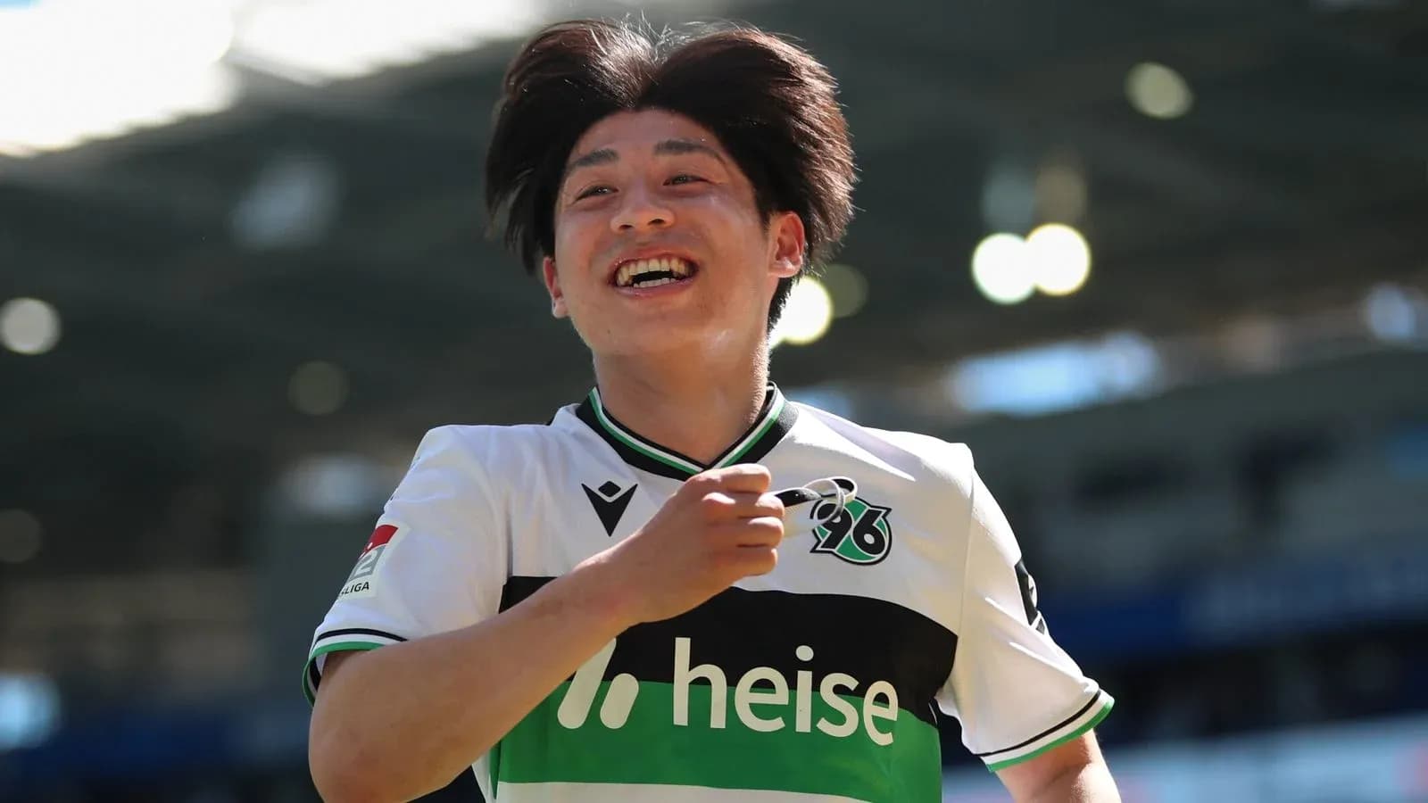 Player celebrating a goal on the pitch Player celebrating a goal on the pitch