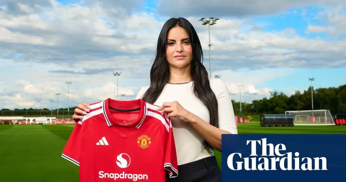 Woman holding Manchester United jersey at training ground Woman holding Manchester United jersey at training ground