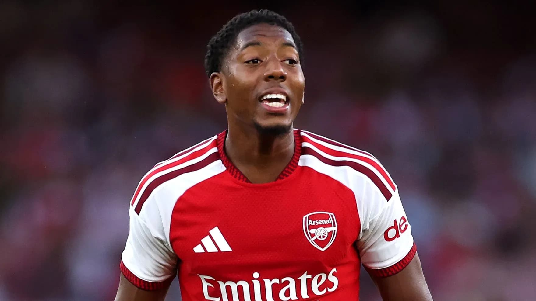 Player celebrating during match wearing Arsenal jersey Player celebrating during match wearing Arsenal jersey