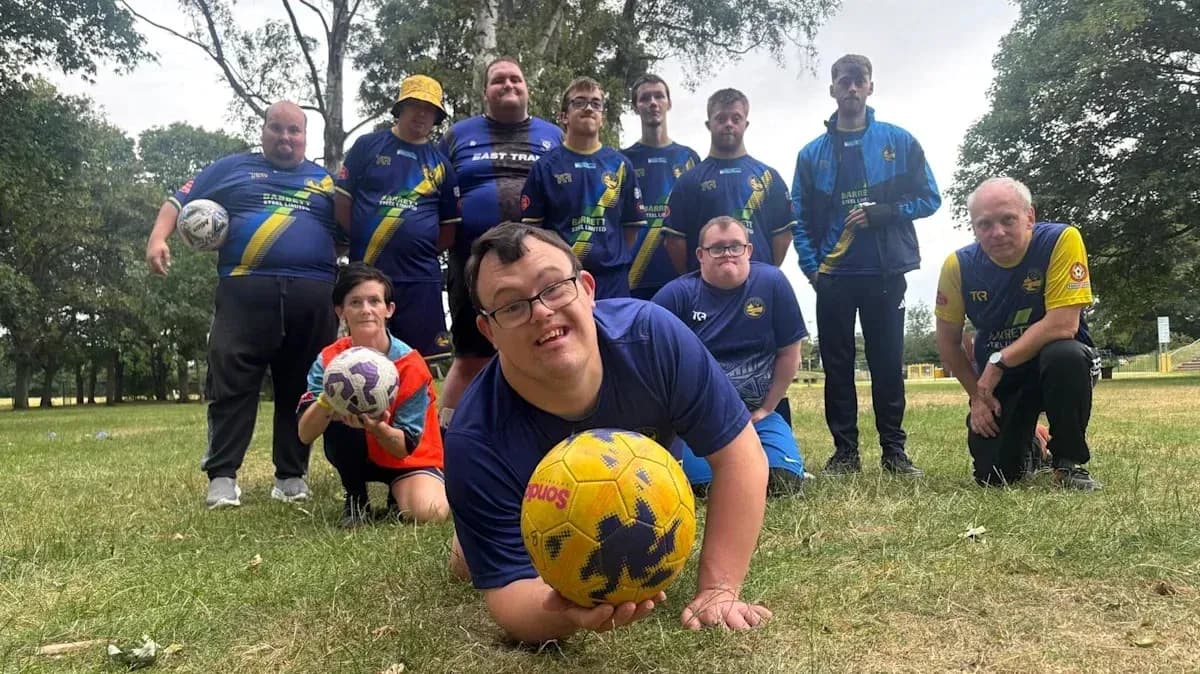 Group of players posing with soccer balls outdoors Group of players posing with soccer balls outdoors