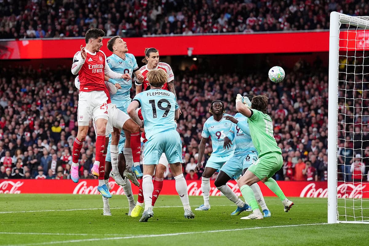 Arsenal player jumping to score against Burnley Arsenal player jumping to score against Burnley