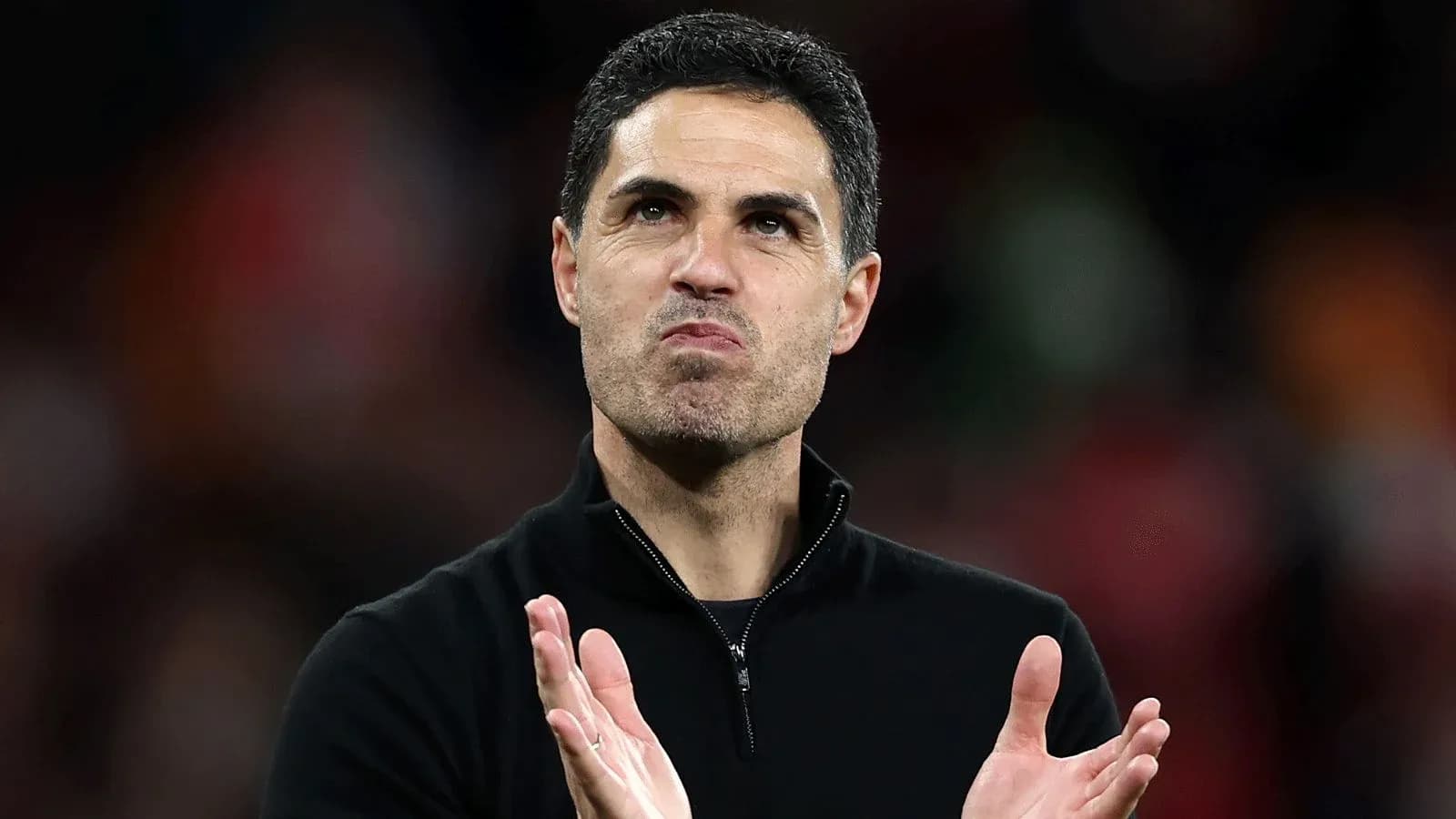 Manager clapping during a match at the stadium Manager clapping during a match at the stadium