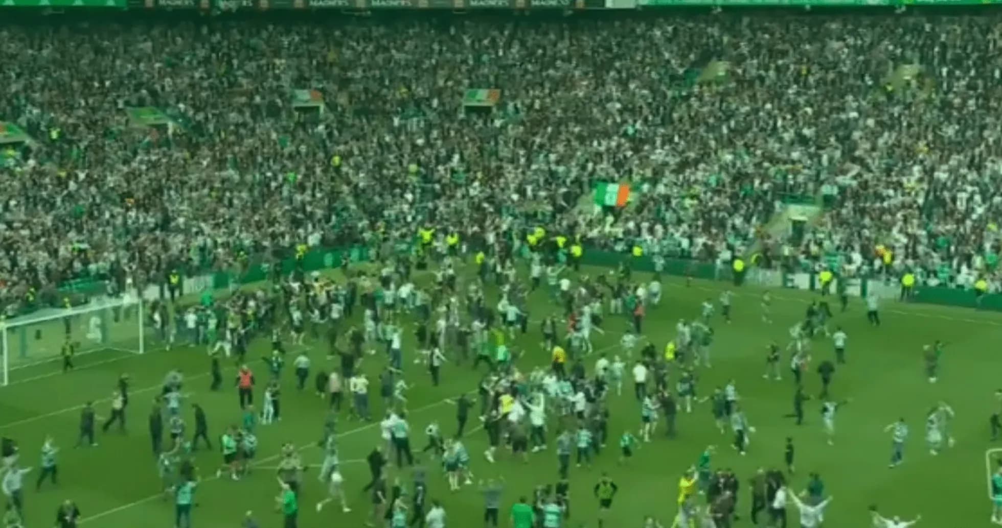 Fans celebrating on the pitch after match Fans celebrating on the pitch after match