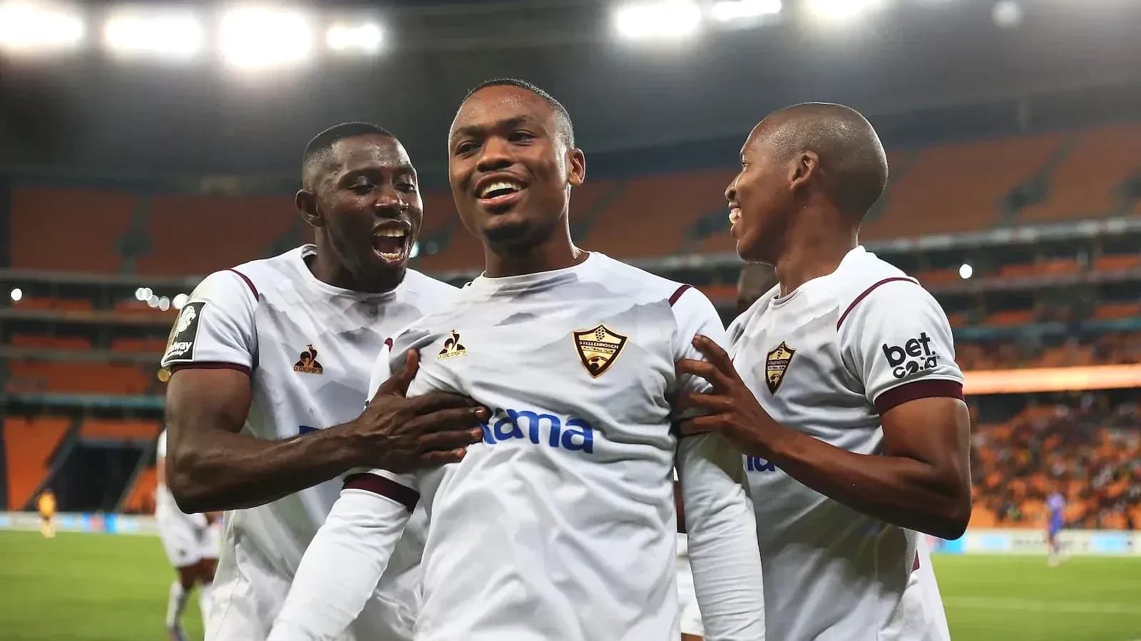 Players celebrating a goal during a football match Players celebrating a goal during a football match