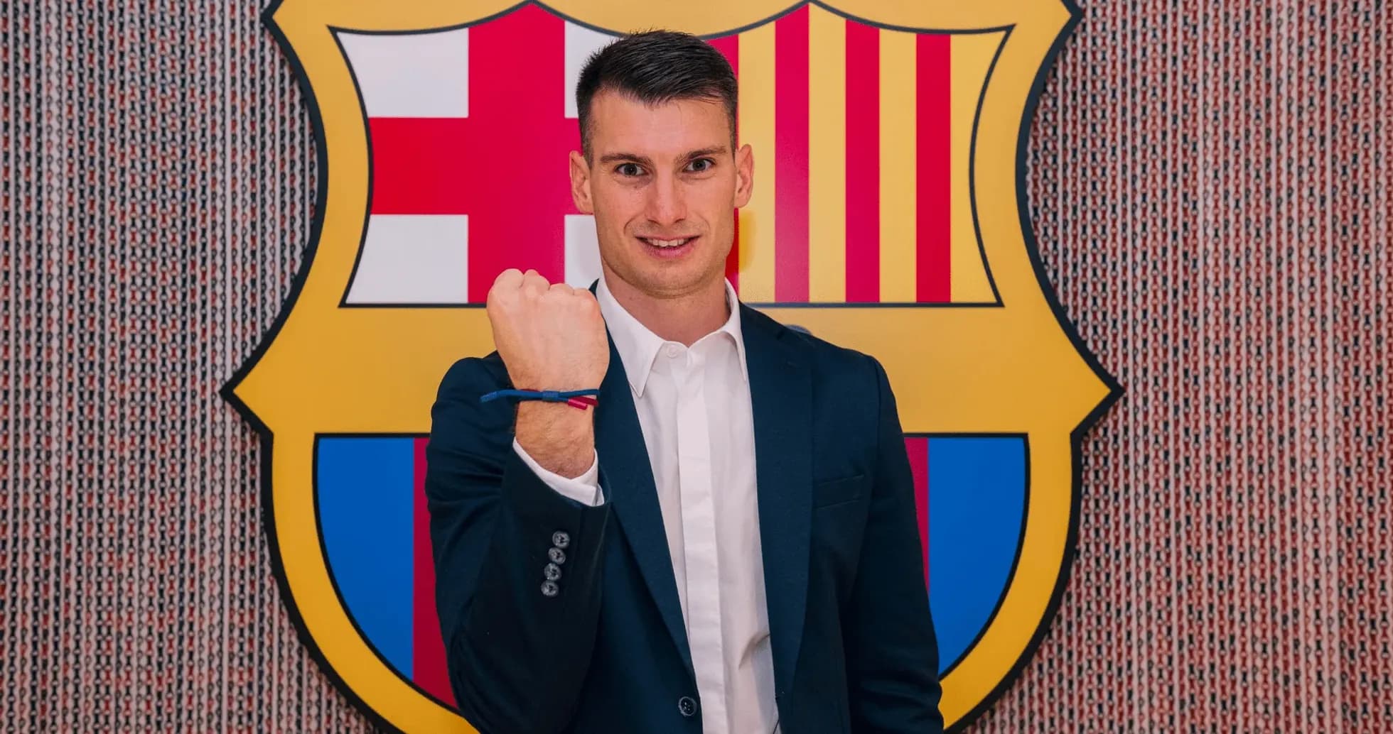 Player posing with clenched fist at FC Barcelona logo Player posing with clenched fist at FC Barcelona logo