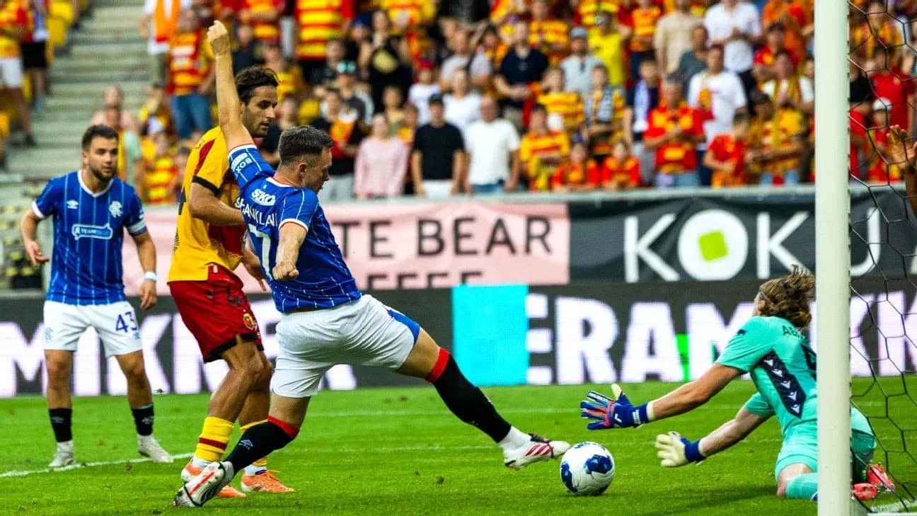 Rangers player shoots at goal against Jagiellonia Rangers player shoots at goal against Jagiellonia