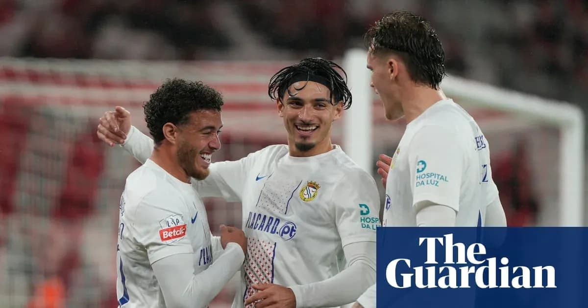 Three players celebrating a goal on the field Three players celebrating a goal on the field