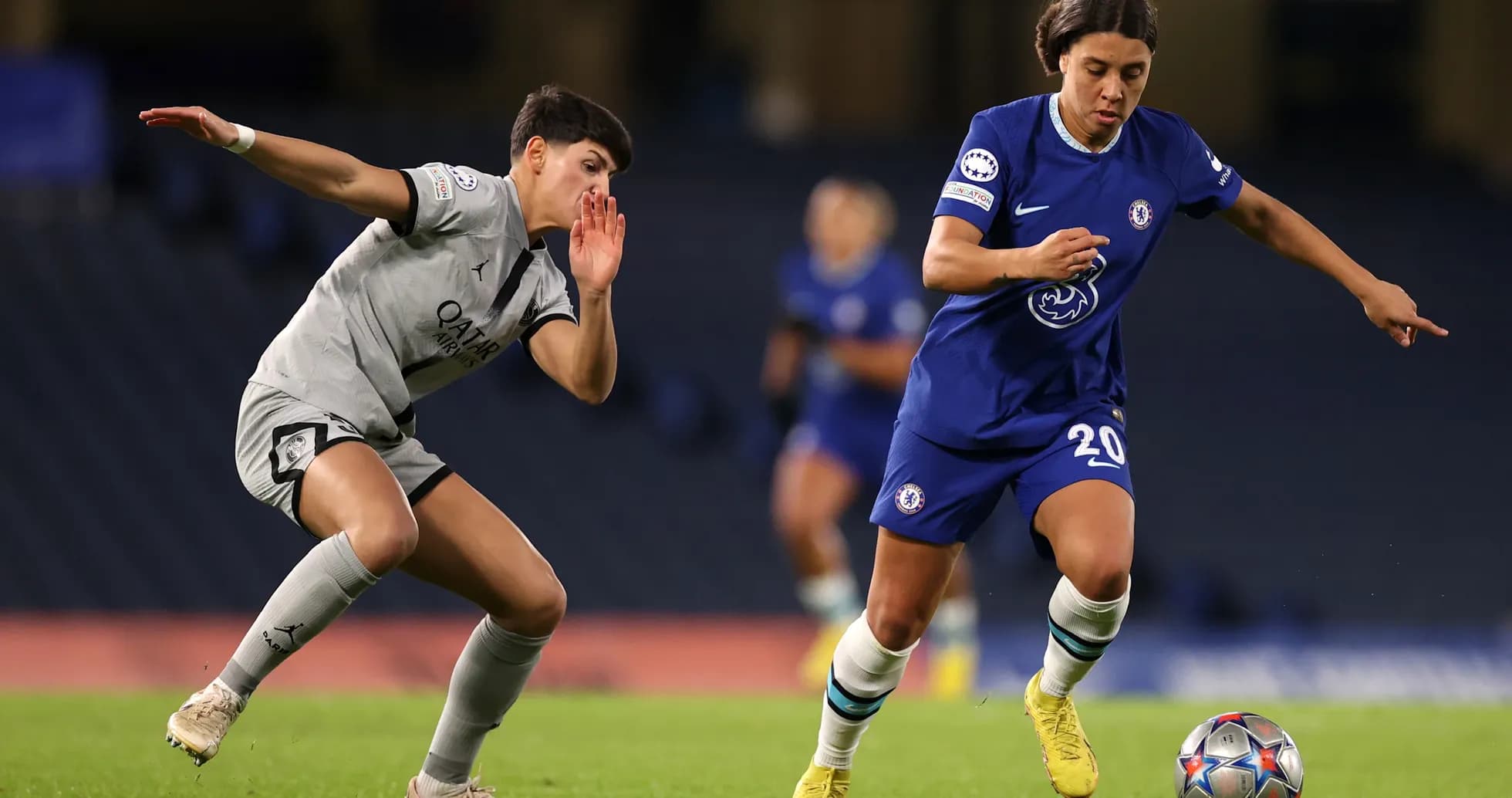 Chelsea player dribbling past PSG opponent Chelsea player dribbling past PSG opponent