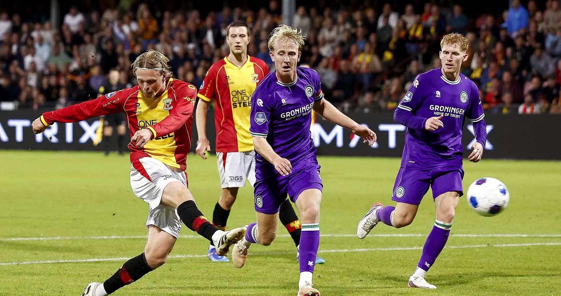 Player shooting the ball during a football match Player shooting the ball during a football match