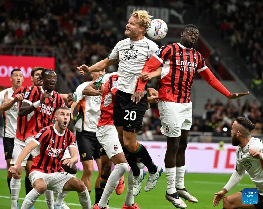 Players contesting a header during AC Milan match Players contesting a header during AC Milan match