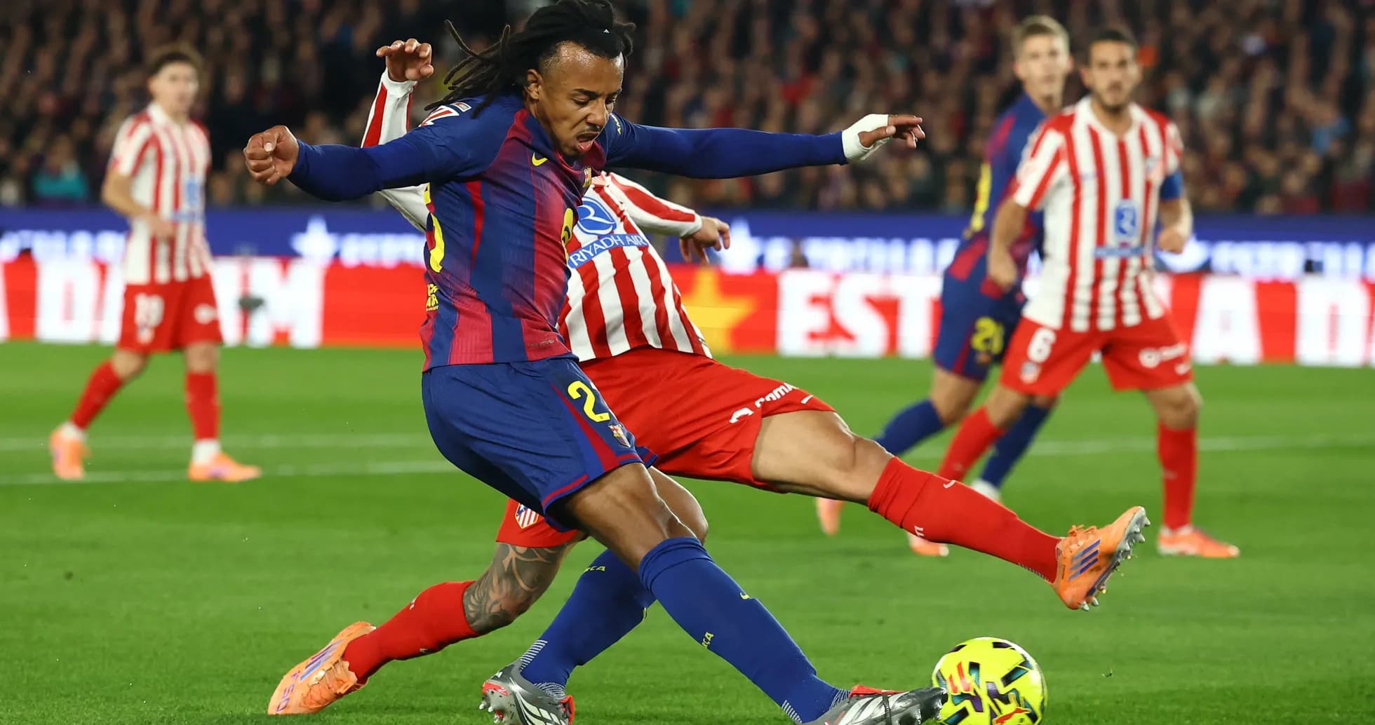 Barcelona player tackling Atletico Madrid opponent Barcelona player tackling Atletico Madrid opponent