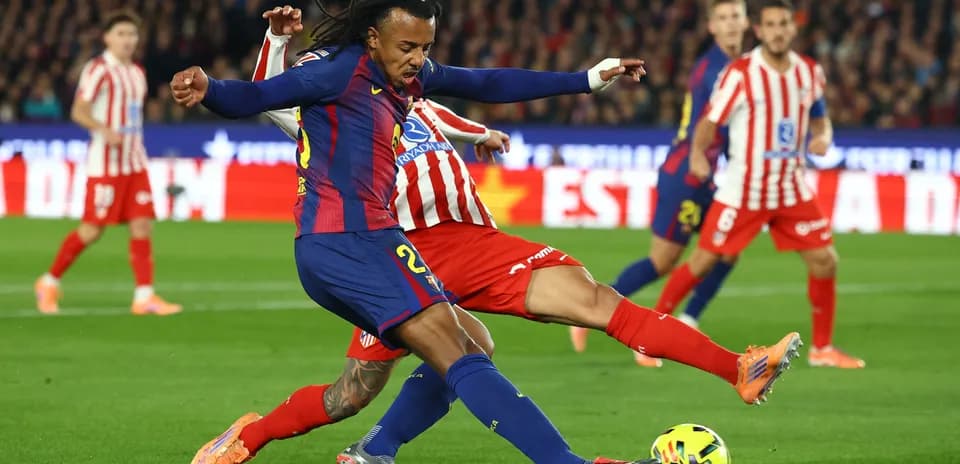 Barcelona player tackling Atletico Madrid opponent Barcelona player tackling Atletico Madrid opponent