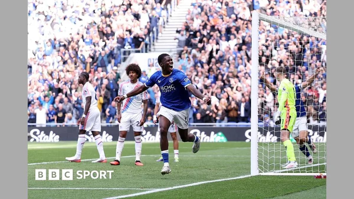 Player celebrating goal with fans in background Player celebrating goal with fans in background