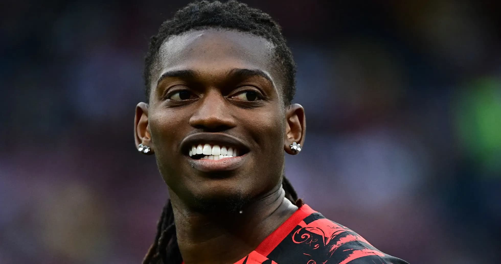 Player smiling in red and black jersey Player smiling in red and black jersey