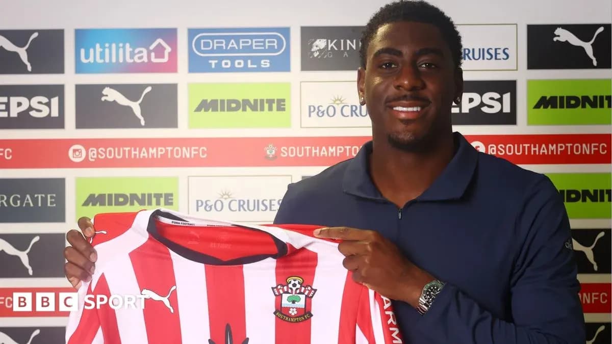 Player holding Southampton FC jersey at signing event Player holding Southampton FC jersey at signing event