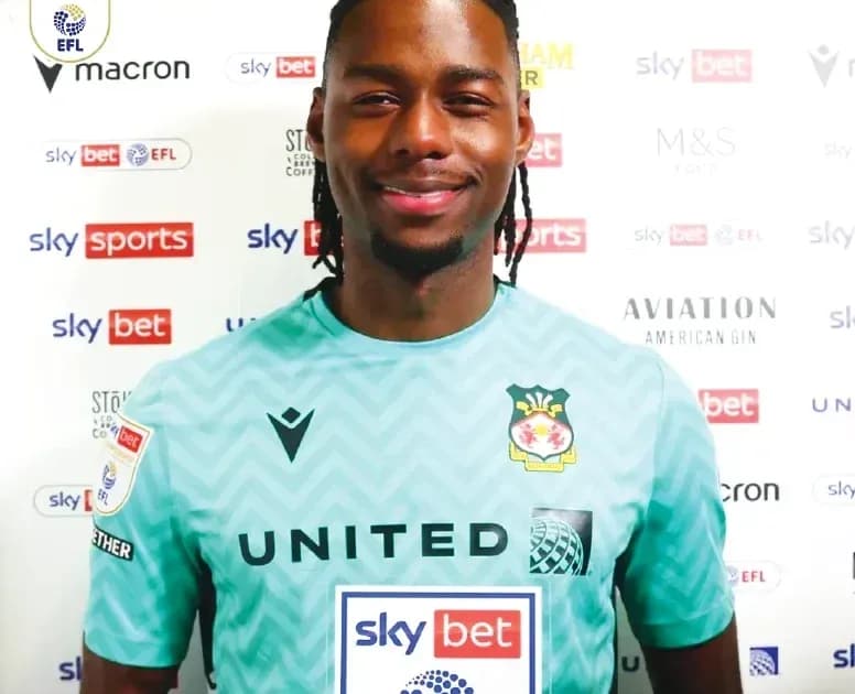 Goalkeeper in team jersey smiling for photo Goalkeeper in team jersey smiling for photo